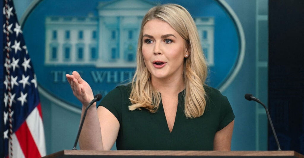 White House Press Secretary Karoline Leavitt speaks at the podium with the White House signage behind her.