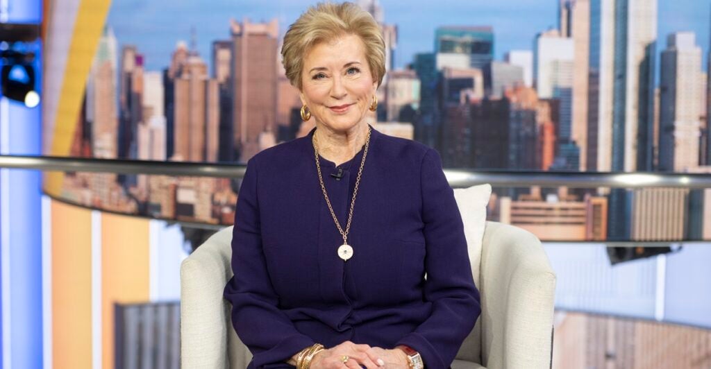 Linda McMahon sits in a chair with her hands place on her lap.