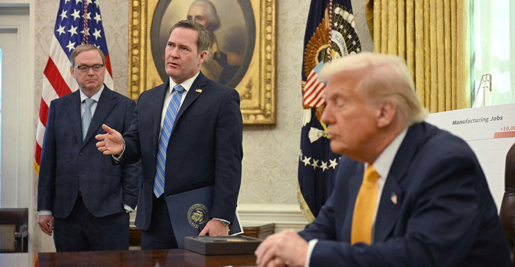 President Donald Trump listens to National Security Adviser Mike Waltz (center) on Friday.
