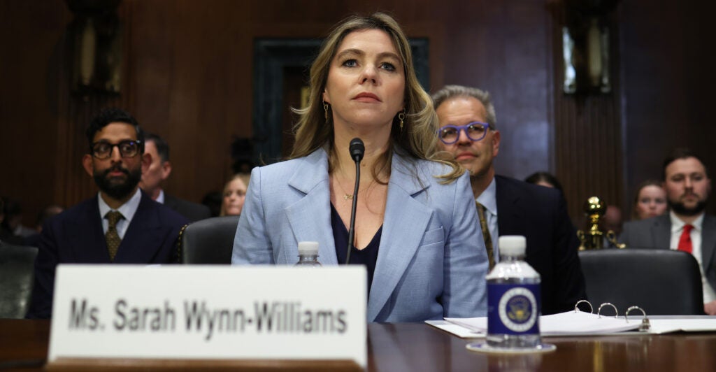 Former Facebook employee Sarah Wynn-Williams sits at a table, in a blue jacket, testifying before Congress.