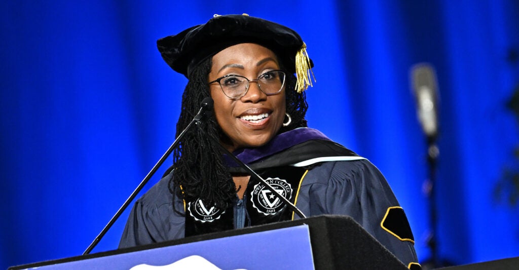 Ketanji Brown Jackson stands at a podium wearing academic regalia.