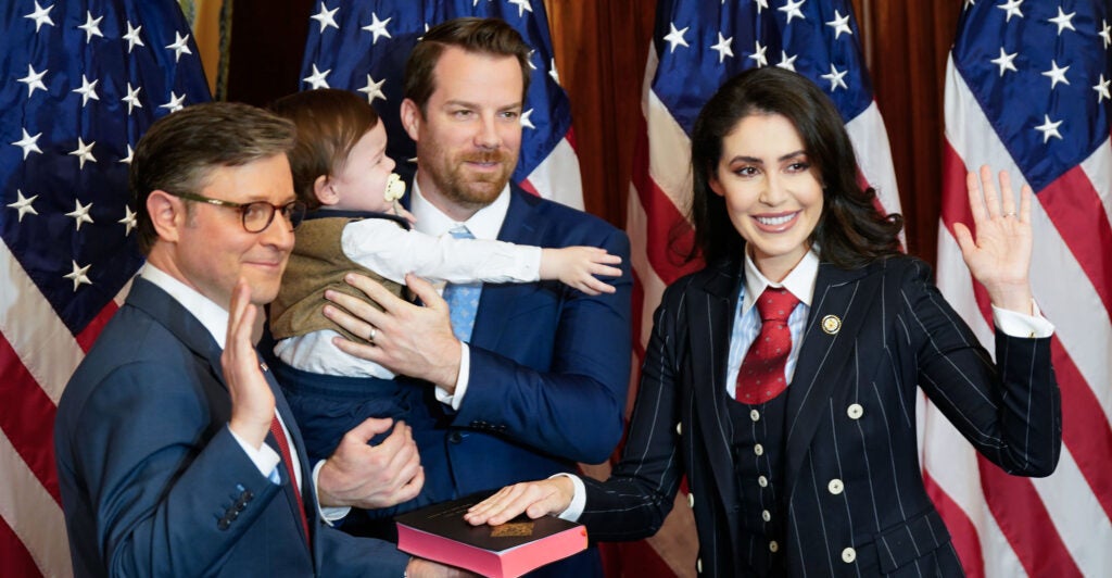 House Speaker Mike Johnson swears in Rep. Anna Paulina Luna as husband and infant child look on.