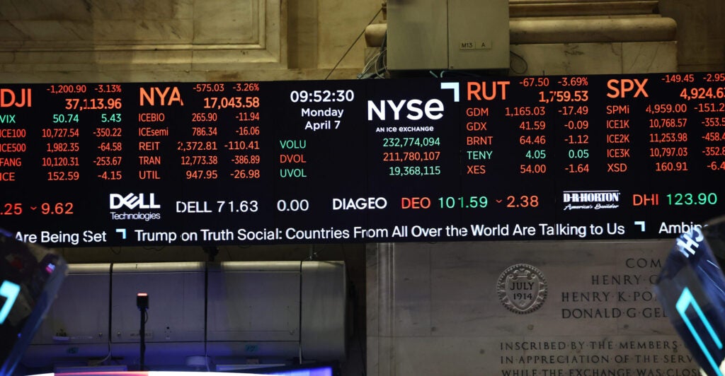 Digital display of New York Stock Exchange board early Monday, with assorted stock prices and news ticker on bottom of screen.
