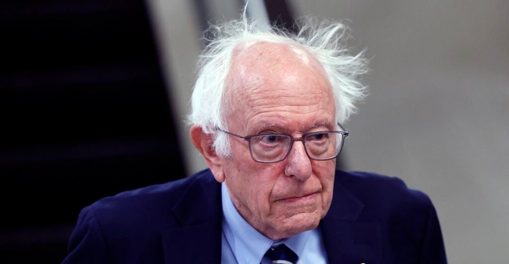 Bernie Sanders looks straight ahead as he walks to his office.