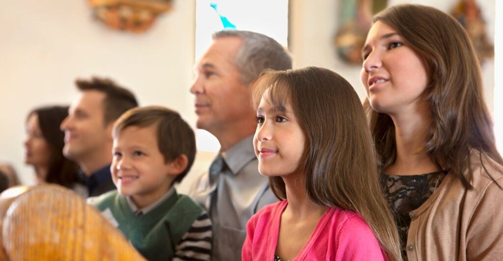 multigenerational family sitting at a pew at a church