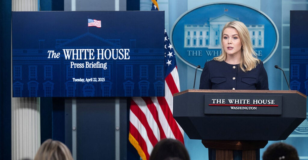 White House press secretary Karoline Leavitt speaks from behind a lectern at her daily briefing Tuesday.