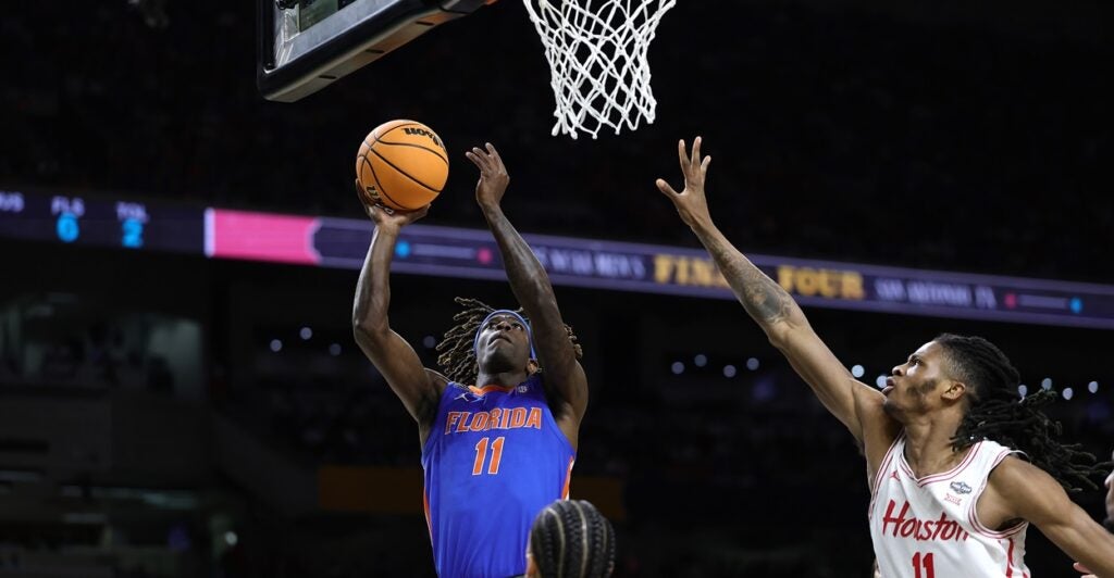 Denzel Aberdeen goes up for a layup with a basketball in his right hand.