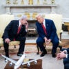 President Donald Trump and Israeli Prime Minister Benjamin Netanyahu lean towards each other in conversation during an Oval Office meeting April 7.