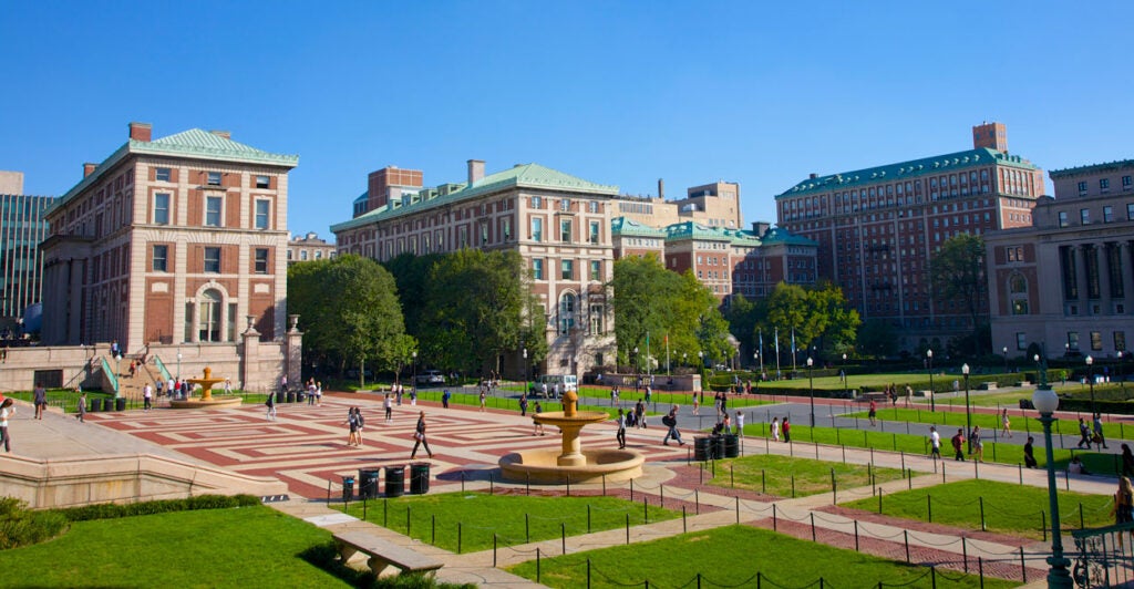 A wide-angle view of Columbia University against a clear blue sky.