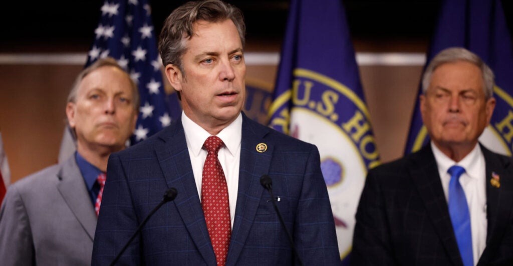 Flanked by Reps. Andy Biggs, R-Ariz. (left) and Ralph Norman, R-S.C., Rep. Andy Ogles, R-Tenn., talks to reporters on March 5, 2024, in Washington.