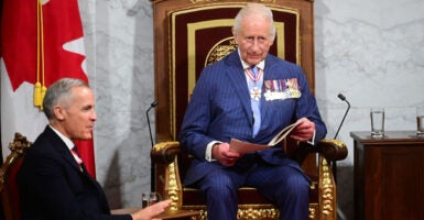 King Charles III delivers a speech from the throne in the Canadian Parliament as Canadian Prime Minister Mark Carney looks on in Ottawa, Ontario, the nation's capital, on Tuesday.