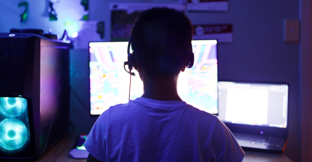 A young student uses artificial intelligence on a computer for learning purposes.