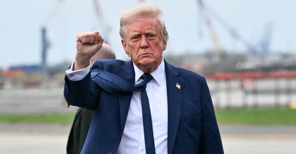 President Donald Trump gestures, shaking a fist.
