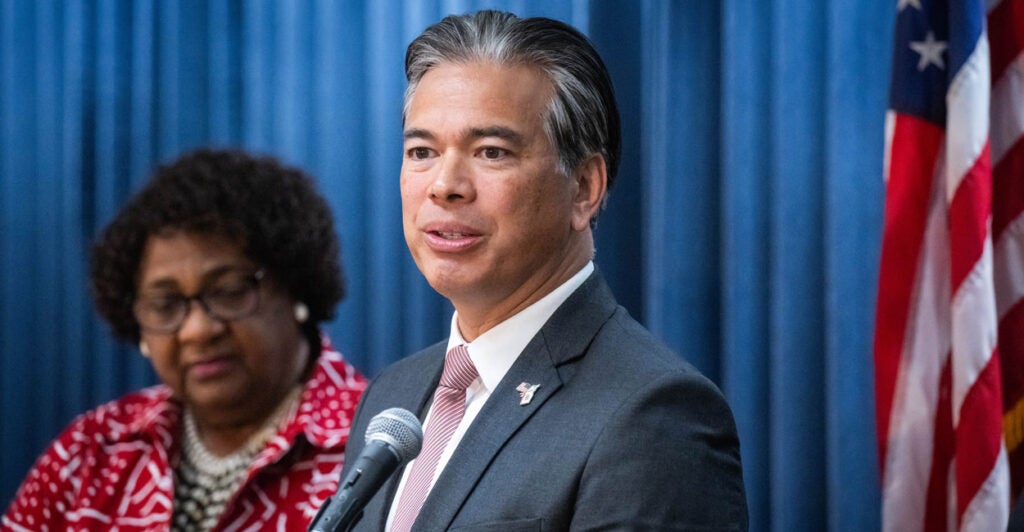 California Attorney General Rob Bonta and Secretary of State Shirley Weber on stage at a news conference