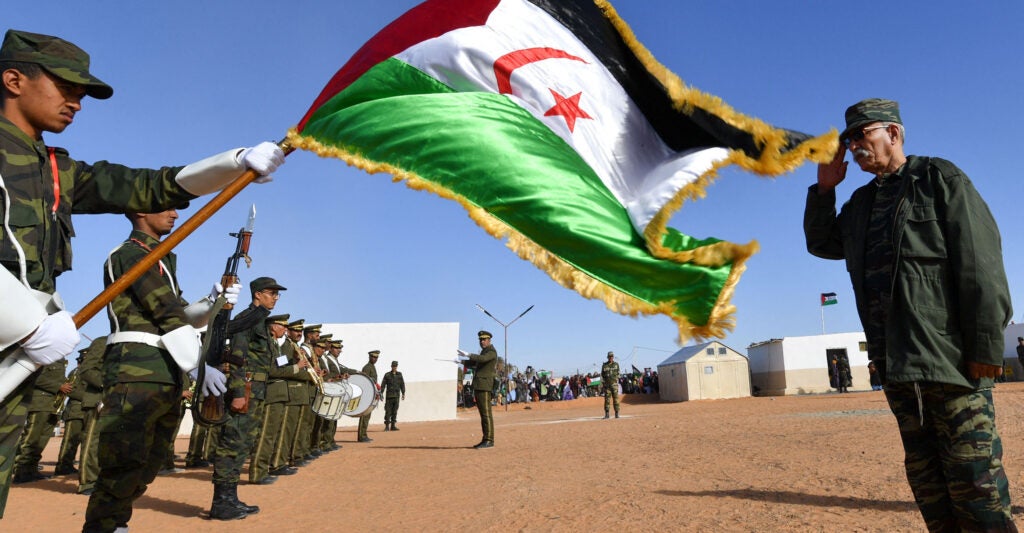 Polisario Secretary General salutes the Sahrawi flag.
