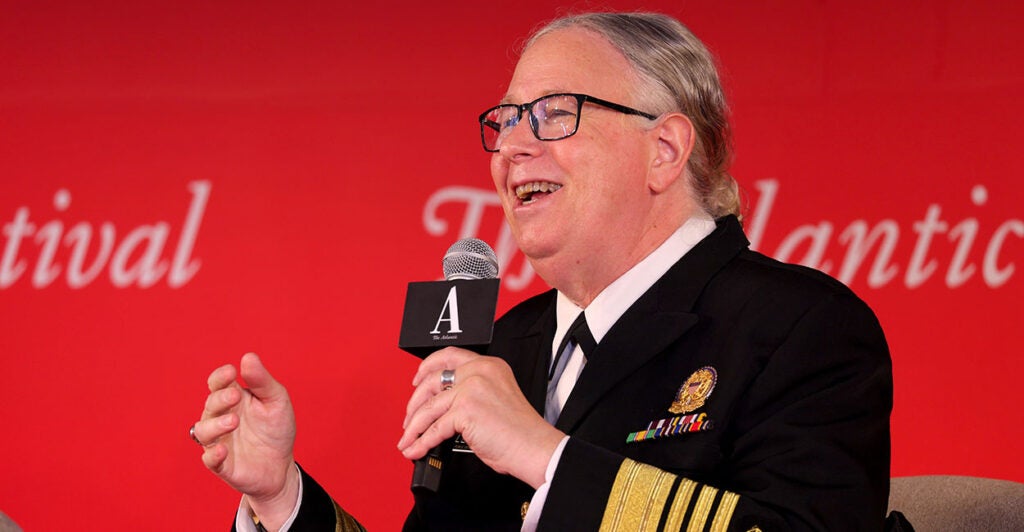 Rachel Levine laughs while holding a microphone