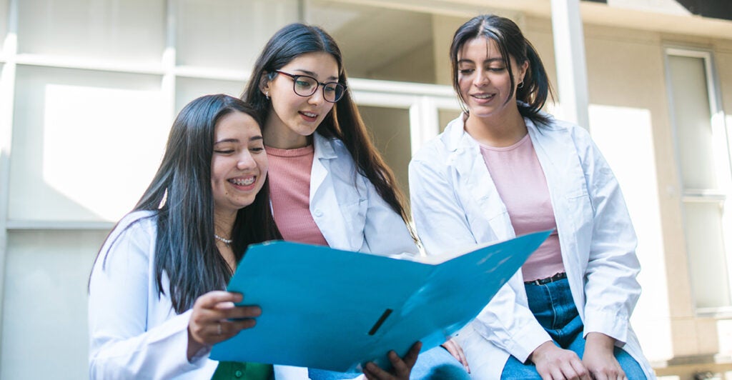Three female medical school students studying