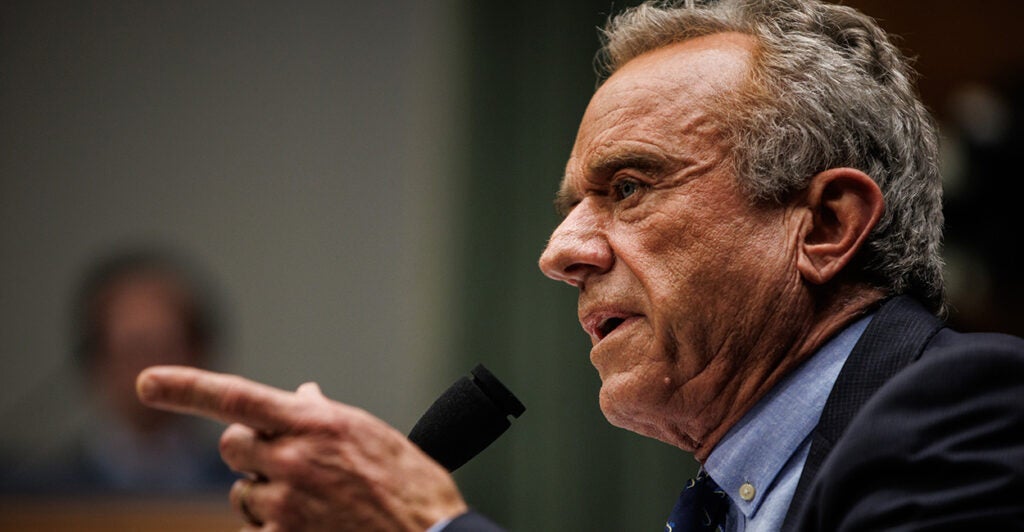 HHS Secretary Robert F. Kennedy in profile pointing during a Senate hearing.