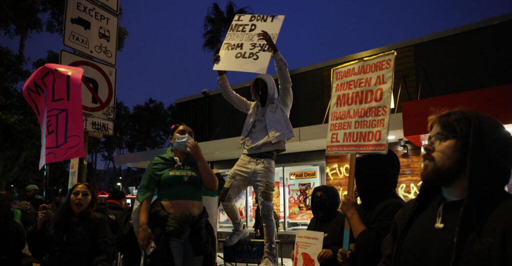 Anti-ICE protesters in front of a vandalized McDonalds in San Francisco.