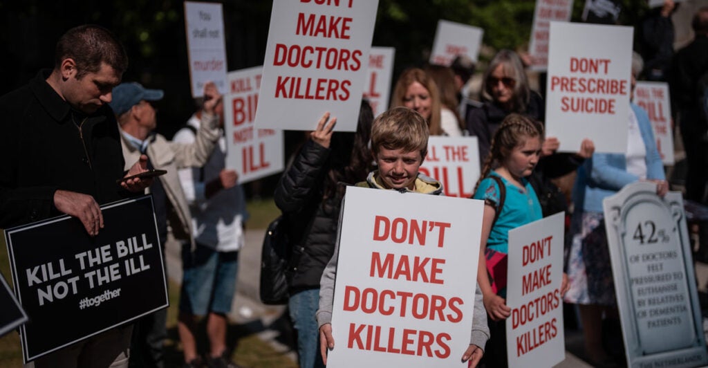 People take part in a demonstration against assisted suicide on May 16 in London.