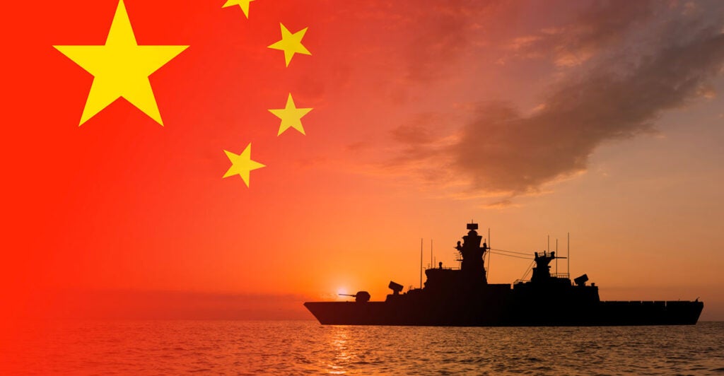A photo illustration of a silhouetted battleship and a dark cloud superimposed on a Chinese flag