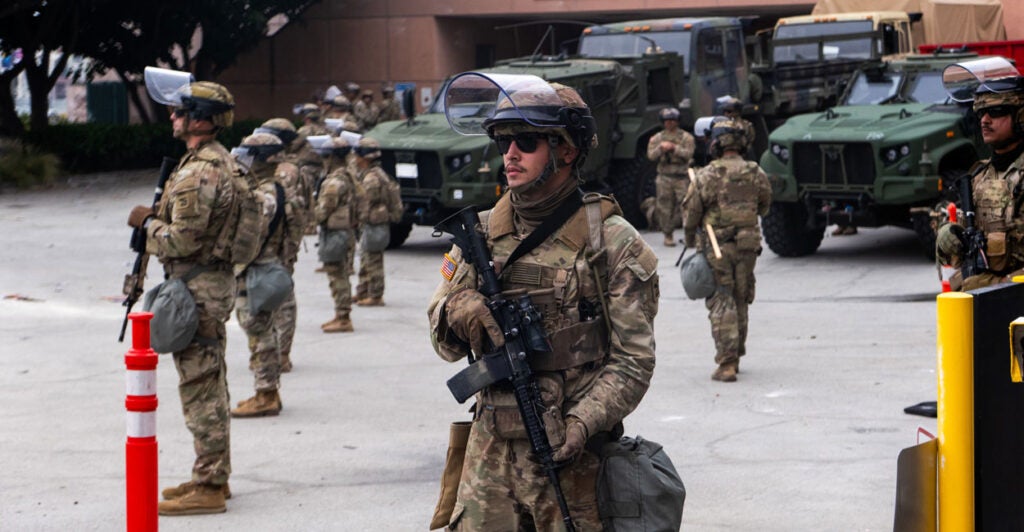 National Guard troops stand outside the Metropolitan Detention Center in Los Angeles on Sunday.