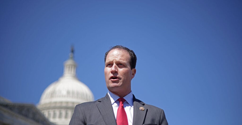 Rep. August Pfluger, R-Texas, speaks in front of the U.S. Capitol against a perfect blue sky.