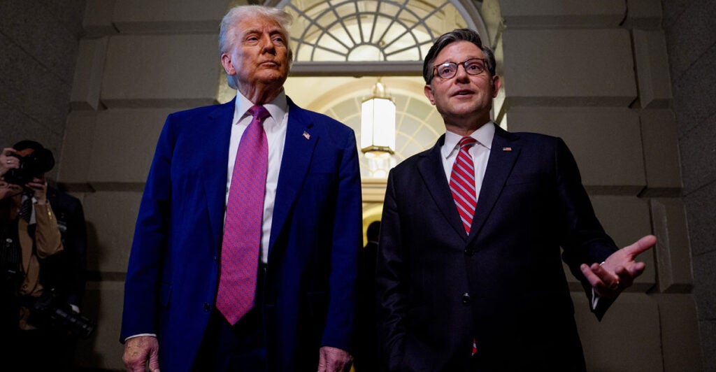 President Donald Trump and House Speaker Mike Johnson stand together inside the U.S. Capitol.