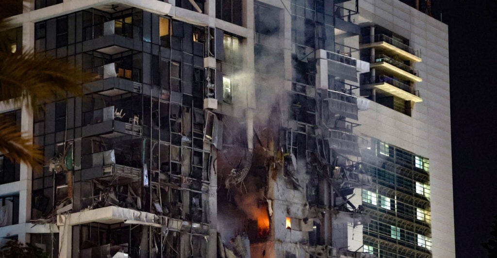 Fire and smoke rise from a building in central Tel Aviv following a strike from Iran on June 13.