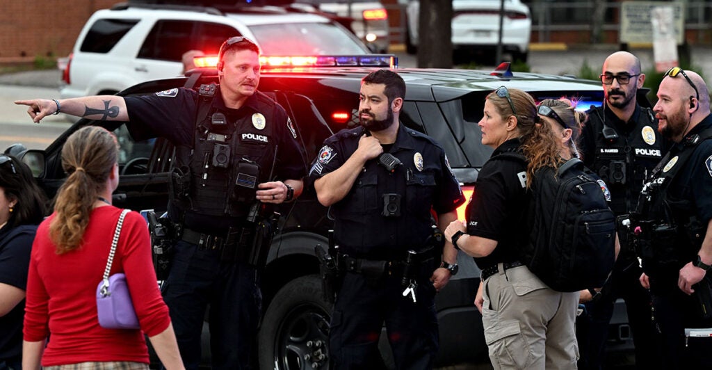 Police officers at the scene of the Boulder arson attack