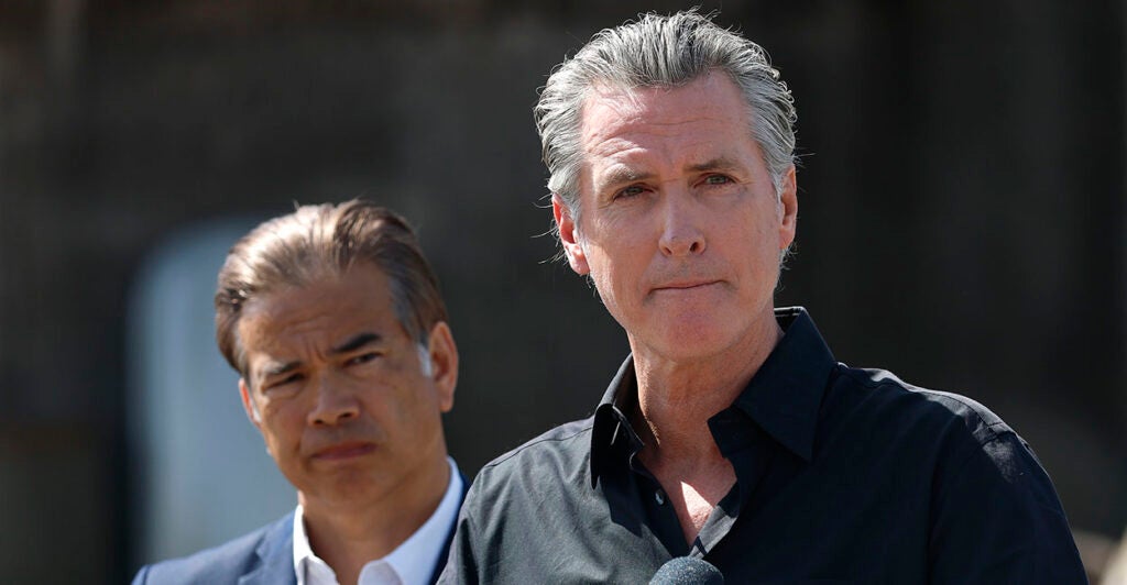 California Gov. Gavin Newsom purses his lips as state AG Rob Bonta looks on.