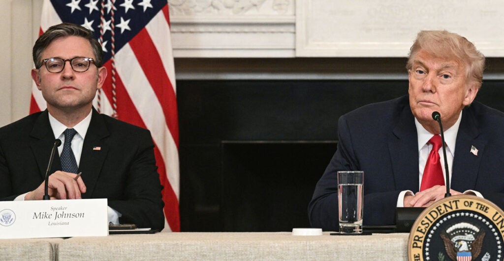 Mike Johnson and Donald Trump in suits