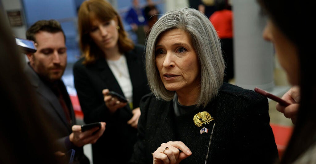 Joni Ernst in black gestures