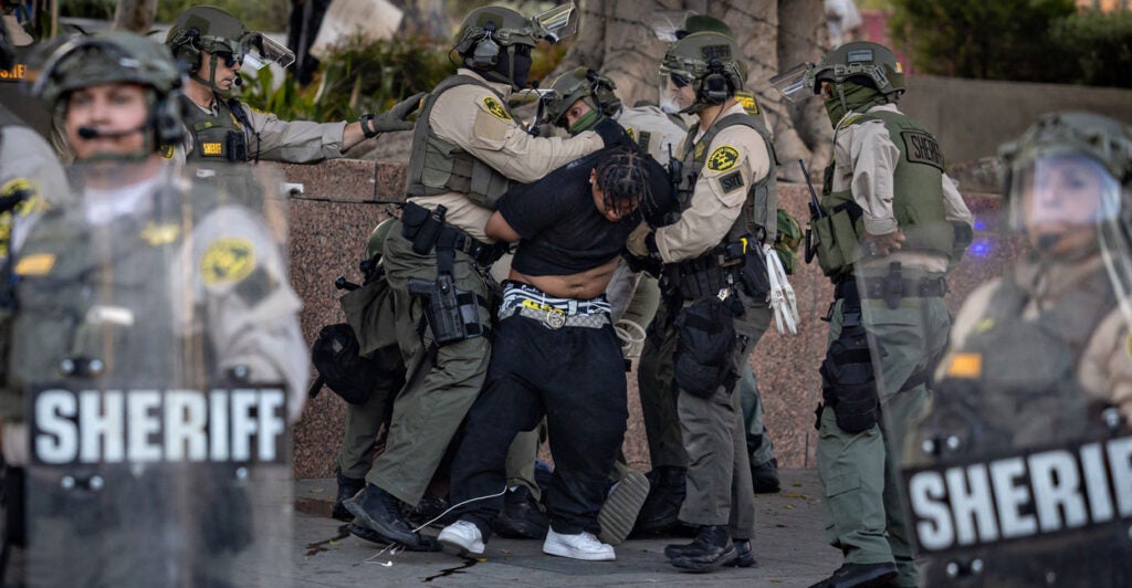 a demonstrator surrounded and arrested by LA Sheriff's deputies