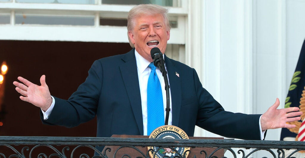 President Donald Trump, wearing a powder-blue tie, speaks to guests from the South Portico of the White House during an event on the South Lawn on Wednesday.
