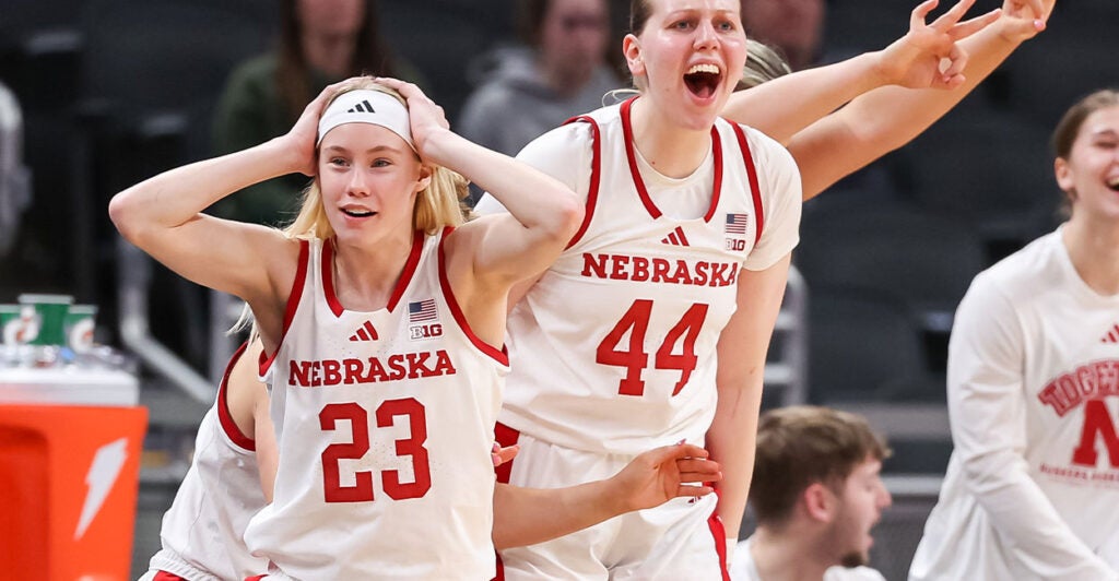 Two Nebraska Women's Basketball players stand side by side.