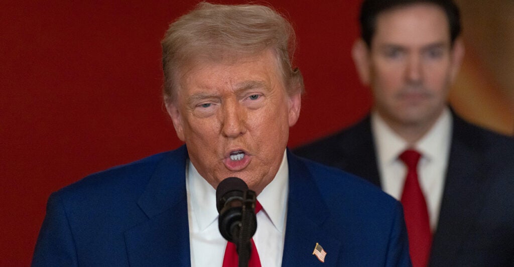 Close-up of President Donald Trump explaining his decision to attack Iran nuclear sites. Secretary of State Marco Rubio stands behind him.