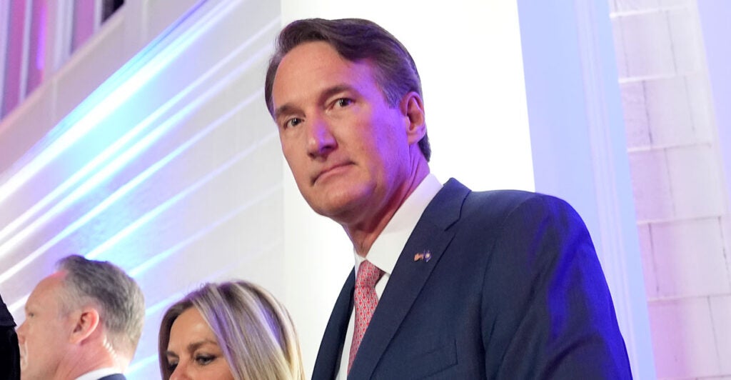 Governor Glenn Youngkin stares forward.