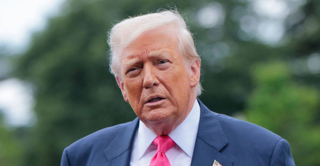 Donald Trump looks straight ahead during a press conference.