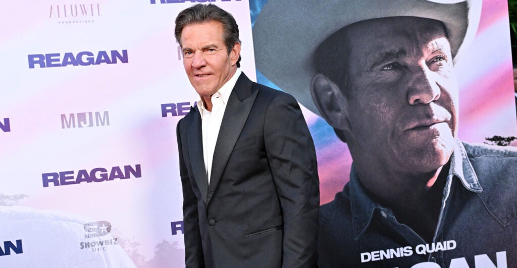 Dennis Quaid stands next to a movie poster for the film "Reagan" at the movie's Los Angeles premiere.
