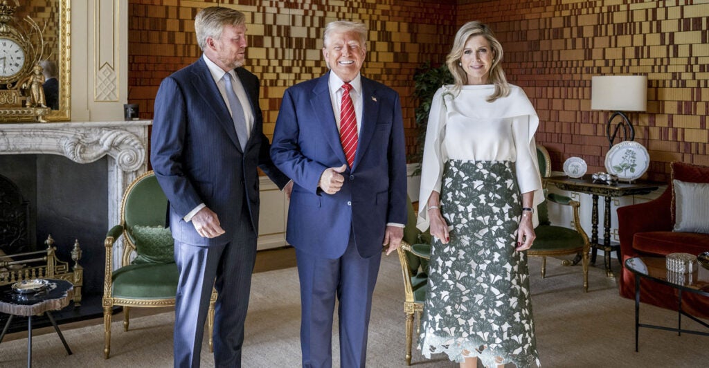 President Donald Trump gives a thumbs up, while flanked by King Willem-Alexander of the Netherlands and Queen Maxima at Paleis Huis ten Bosch in The Hague.