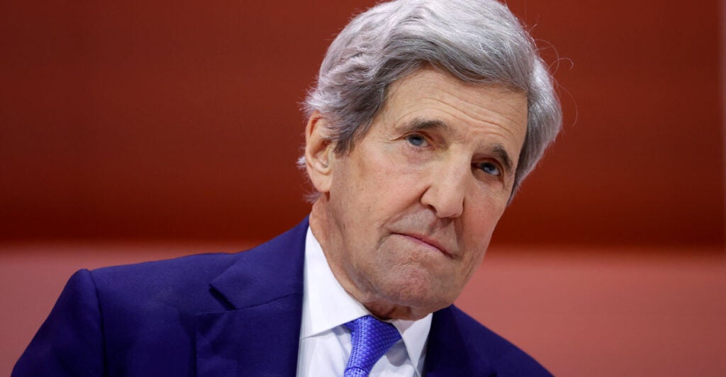 Close-up of John Kerry, in a blue jacket and blue tie.
