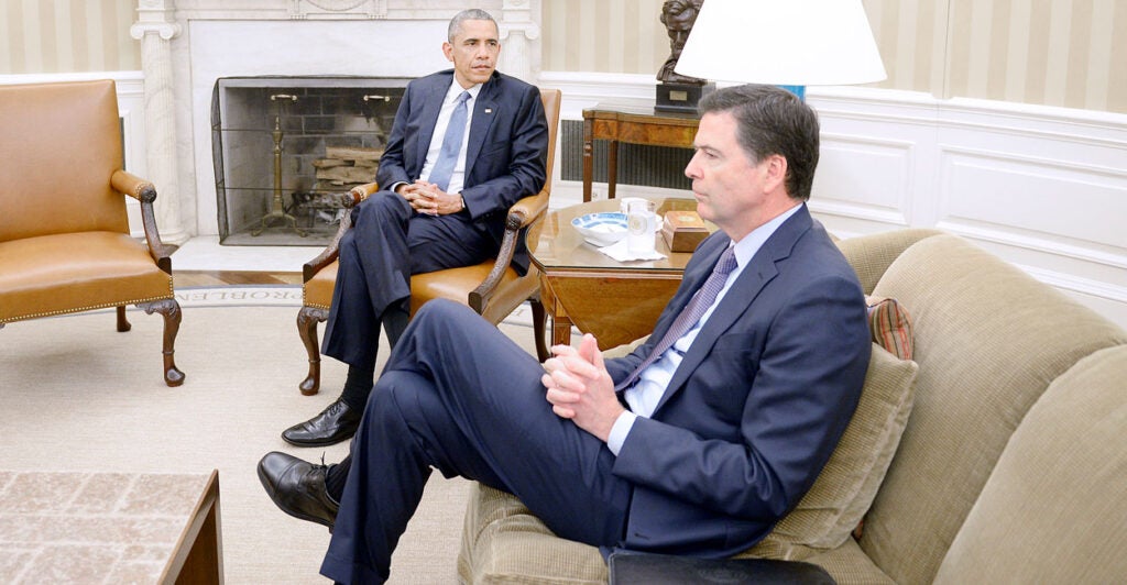 Barack Obama and James Comey sit in the Oval Office.