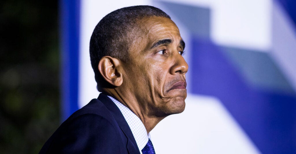 A frowning Barack Obama in profile.