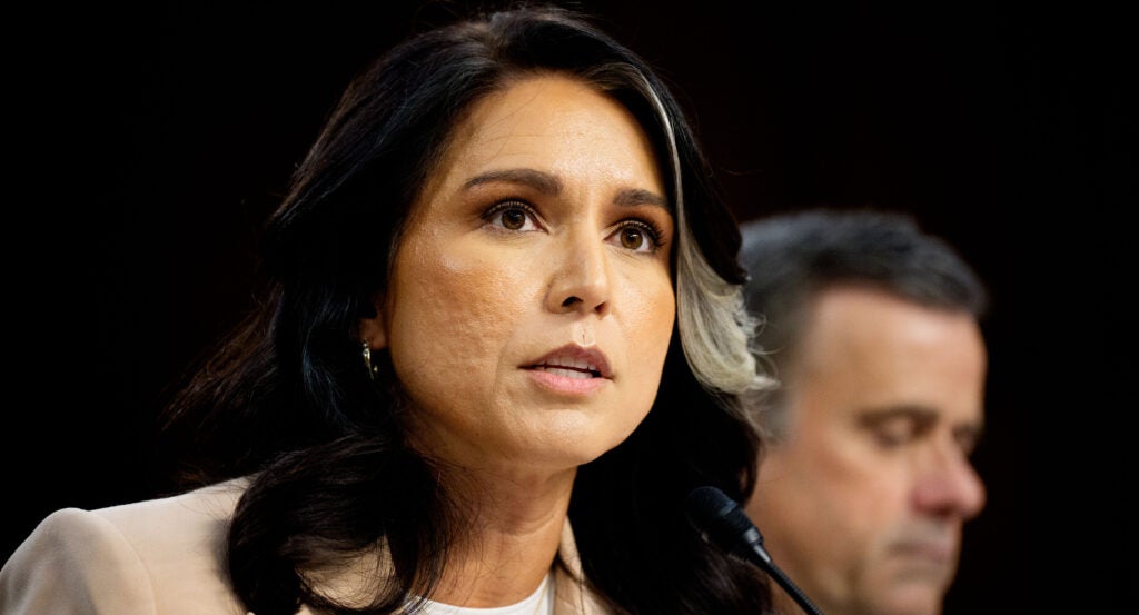 Tulsi Gabbard is looking straight ahead during a hearing.