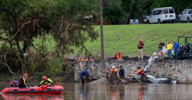 Rescuers are working on land and on water to remove debris and look for survivors.