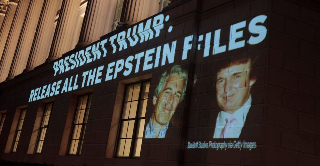 An image of U.S. President Donald Trump and Jeffrey Epstein, along with the words “President Trump: Release All the Epstein Files,” projected onto the U.S. Department of Commerce headquarters.