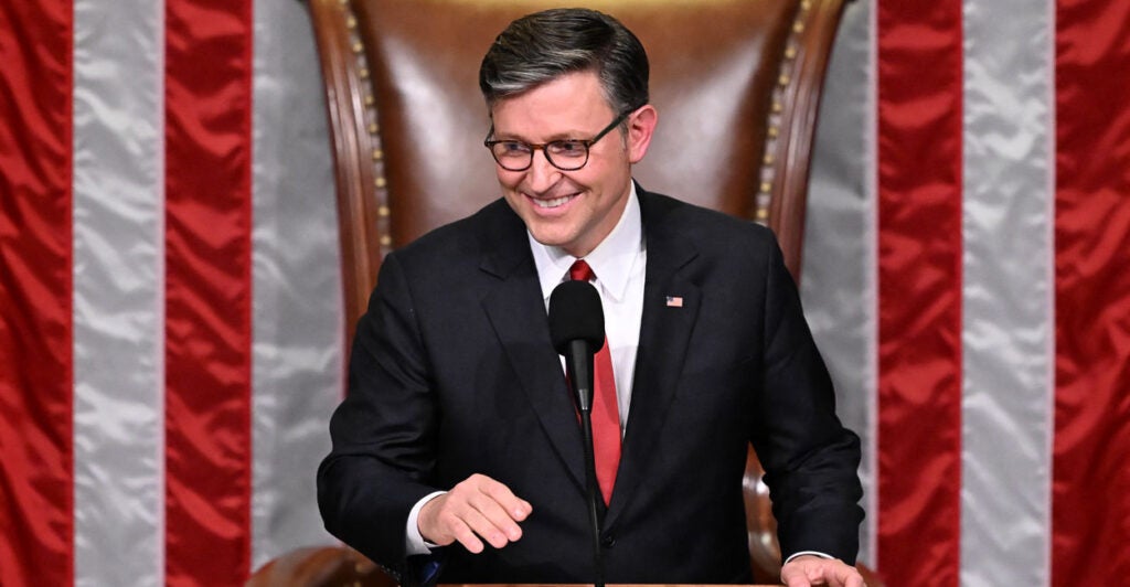 Speaker of the House Mike Johnson, R-La., in the speaker's chair with American flags as a backdrop