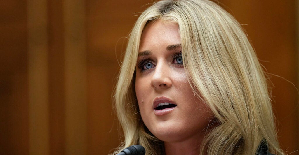 Riley Gaines with a nondescript background