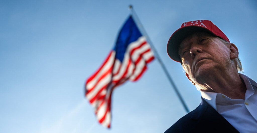 Low angle close-up of President Donald Trump in front of American Flag.